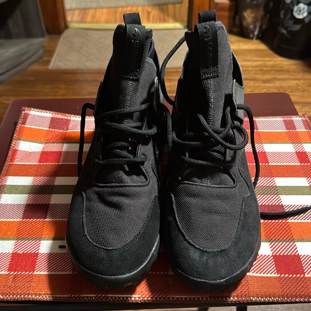All black adidas tubular sneakers
